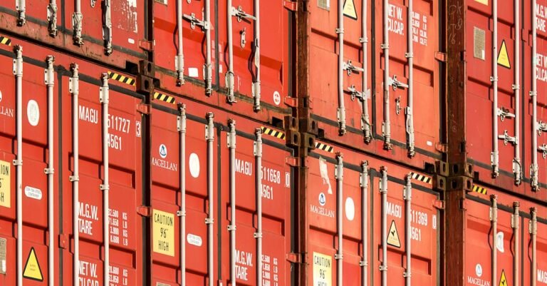 Close-up of stacked red shipping containers used for logistics and global trade.